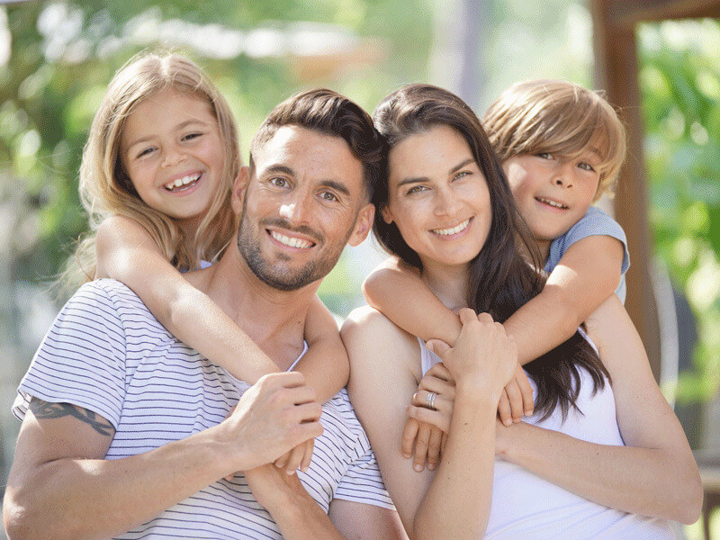 Happy smiling family outside on summer day