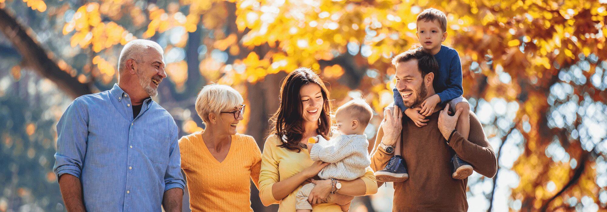 A big multigenerational family walking in autumn