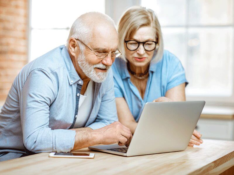 An elderly couple looking through their options on a law website