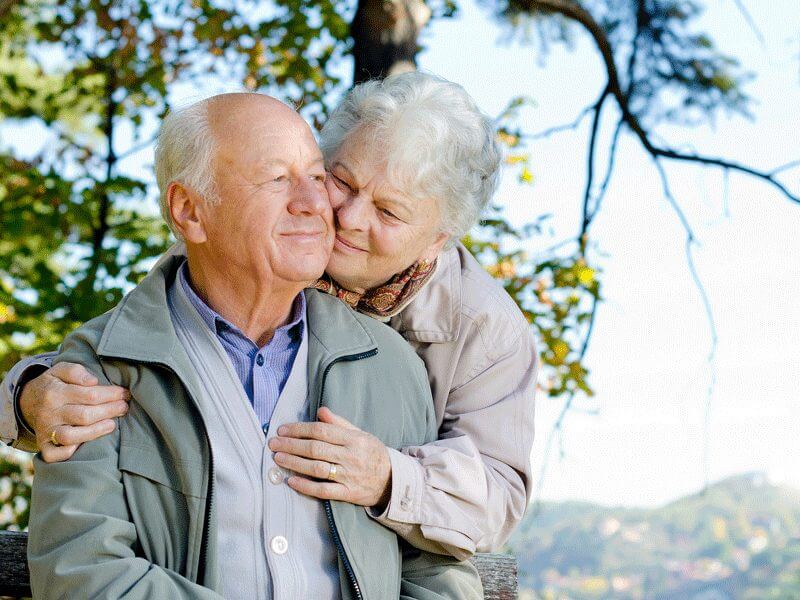 Cute old couple embracing outdoors