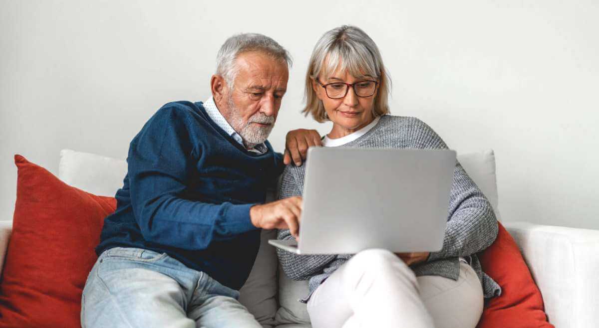 Senior couple family using laptop computer together.