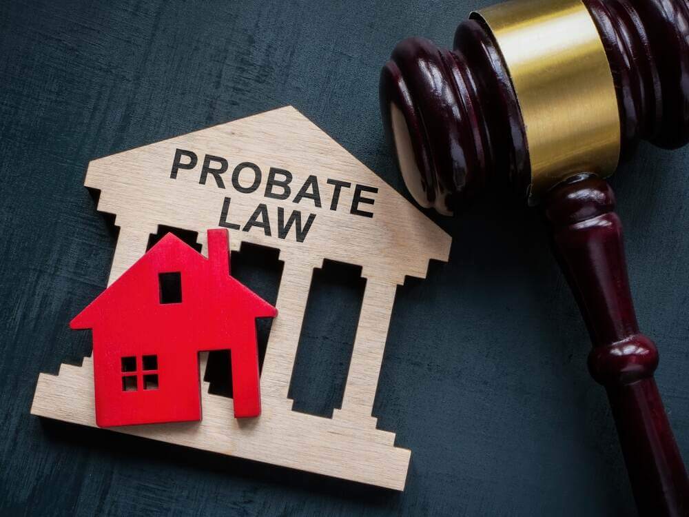 Probate law concept red wooden house with judges gavel on table