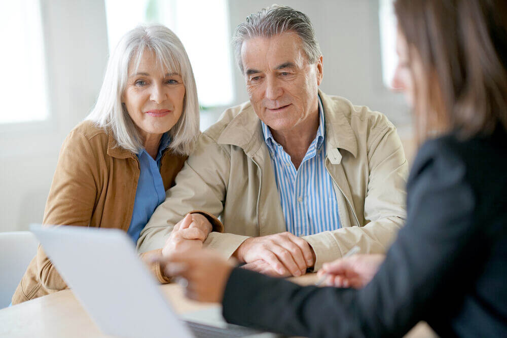 Senior man and woman meeting with an estate planning attorney to discuss their estate plans 