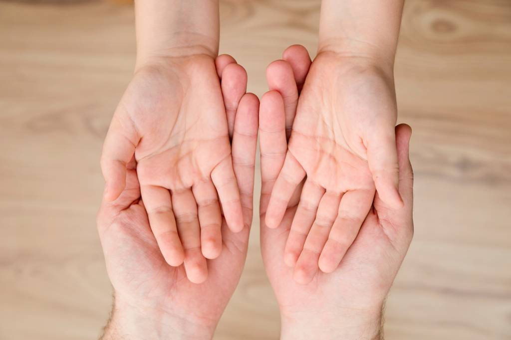 Adult Holding Child’s Hands In Palms