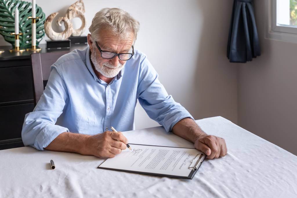 An Elderly Man Signing His Will