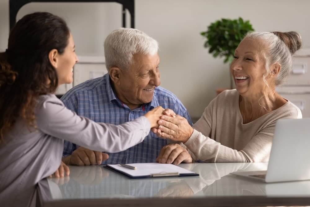 Happy Senior Couple With Estate Planning Attorney Learning How To Create A Will In California