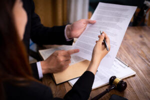 A lawyer showing a man documents to sign