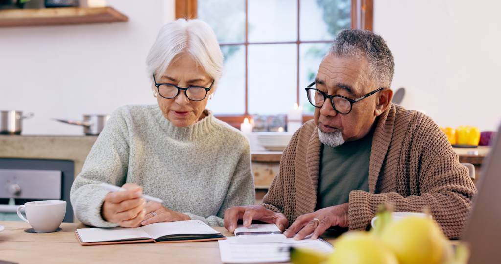 A senior couple looking at paperwork.
